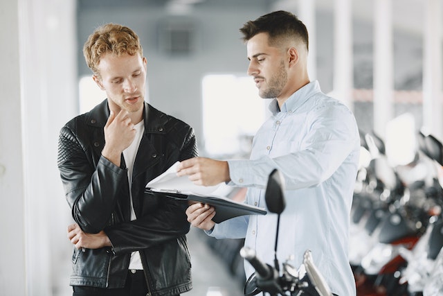 two men discussing the contents of a vehicle protection plan