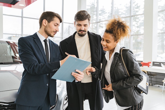 people discussing the differences between buyng new vs used car