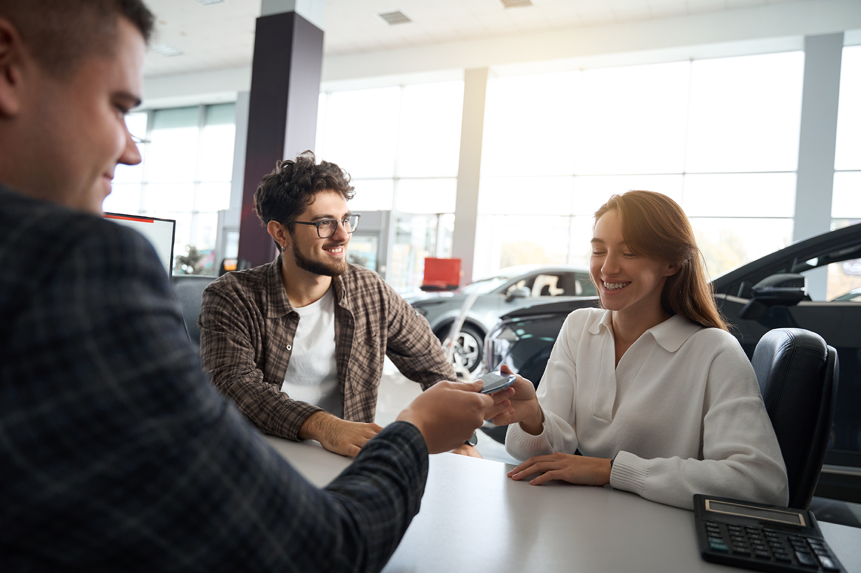 Buying a car at the dealership and getting the keys from the salesman